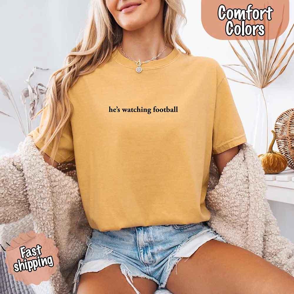 He’s Watching Football Tee - Comfort Colors Funny Shirt for Her