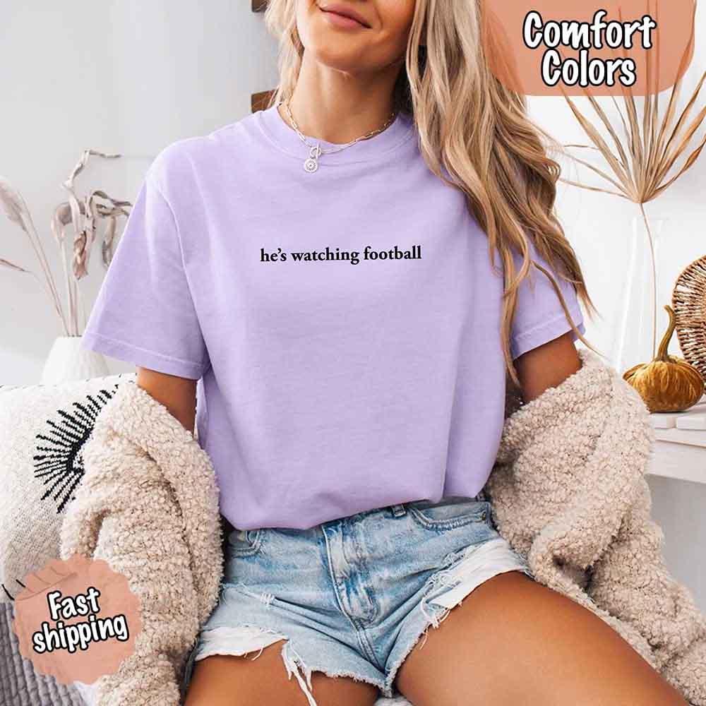 He’s Watching Football Tee - Comfort Colors Funny Shirt for Her