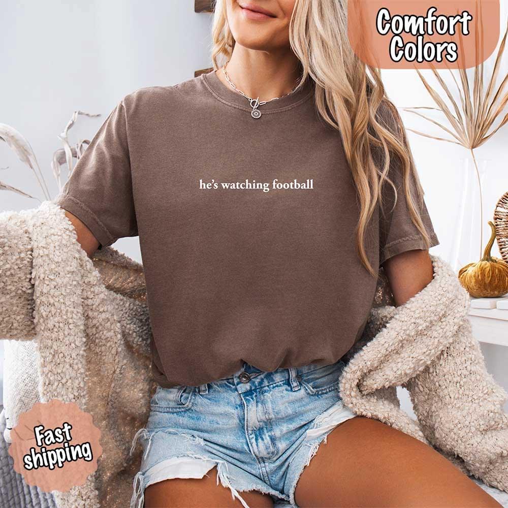 He’s Watching Football Tee - Comfort Colors Funny Shirt for Her